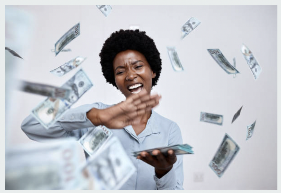 A young woman is throwing money around
